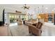 Bright living room featuring wood floors and sliding doors to the outdoor space at 1182 Allaire Loop, The Villages, FL 32163