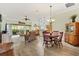 Open concept living and dining area with wood floors and natural light at 1182 Allaire Loop, The Villages, FL 32163