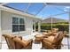 This enclosed patio provides comfortable wicker furniture and a bright and airy space for relaxation or entertaining at 1182 Allaire Loop, The Villages, FL 32163