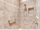 Tiled shower features a handheld shower head, safety bar, and built-in niche at 1182 Allaire Loop, The Villages, FL 32163