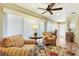 Inviting sunroom with large windows offering views of the manicured backyard, and comfortable seating at 1182 Allaire Loop, The Villages, FL 32163