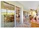 Sunroom with sliding glass doors offering views of the interior and backyard, and comfortable seating at 1182 Allaire Loop, The Villages, FL 32163