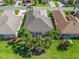 Overhead image of a home with a screened lanai, surrounded by mature palm trees and a lush green lawn at 11820 Se 178Th St, Summerfield, FL 34491