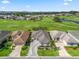 Stunning aerial shot showcasing homes along the golf course, each with meticulously landscaped yards and driveways at 11820 Se 178Th St, Summerfield, FL 34491