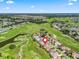 Panoramic aerial view of the property nestled in a golf course community with lush green surroundings and serene water features at 11820 Se 178Th St, Summerfield, FL 34491