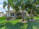 Lush backyard with mature palm trees and a screened-in lanai, ideal for outdoor living and entertaining at 11820 Se 178Th St, Summerfield, FL 34491