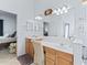 Bright bathroom featuring double sinks, a vanity area, and a large mirror for added convenience at 11820 Se 178Th St, Summerfield, FL 34491