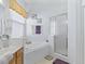 Bright bathroom featuring vanity, soaking tub, and glass-enclosed shower at 11820 Se 178Th St, Summerfield, FL 34491