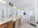Bright bathroom featuring dual sinks, soaking tub, and separate shower at 11820 Se 178Th St, Summerfield, FL 34491
