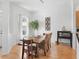 Dining area showcases rustic wood table, modern lighting, and bright natural light at 11820 Se 178Th St, Summerfield, FL 34491