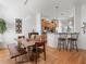 Eat-in kitchen with a dining area featuring a rustic wood table and bar seating at the counter at 11820 Se 178Th St, Summerfield, FL 34491