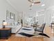 Bright living room featuring white sofa, stylish chairs, and a decorative rug on wood flooring at 11820 Se 178Th St, Summerfield, FL 34491