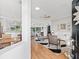 Open-concept living area with hardwood floors and abundant natural light at 11820 Se 178Th St, Summerfield, FL 34491