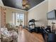 Bright home office with a fan, a dark ceiling and a treadmill next to a large window at 11820 Se 178Th St, Summerfield, FL 34491