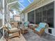 Inviting screened patio with wicker furniture, perfect for enjoying the outdoors in comfort at 11820 Se 178Th St, Summerfield, FL 34491