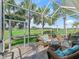 Screened patio with comfortable wicker furniture, offering a relaxing outdoor living space with a view at 11820 Se 178Th St, Summerfield, FL 34491
