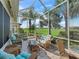 Comfortable screened patio with wicker furniture and relaxing green view at 11820 Se 178Th St, Summerfield, FL 34491