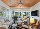 Inviting sunroom featuring large windows, stylish furniture, and views to outside at 11820 Se 178Th St, Summerfield, FL 34491