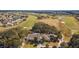 Aerial view of a sprawling estate overlooking a lush golf course with mature trees at 11884 Se 179Th St, Summerfield, FL 34491