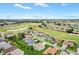 Aerial view of a residential community with a golf course and ponds in a suburban neighborhood at 11884 Se 179Th St, Summerfield, FL 34491