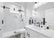 Bathroom featuring a glass shower, sleek fixtures, and a bright white vanity with undermount sink and quartz counters at 11884 Se 179Th St, Summerfield, FL 34491