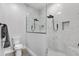 Modern bathroom with white marble tile, glass shower enclosure and sleek black fixtures at 11884 Se 179Th St, Summerfield, FL 34491