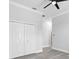 A bright bedroom featuring a ceiling fan, crown molding, closet and neutral color scheme at 11884 Se 179Th St, Summerfield, FL 34491