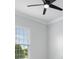 A bright and airy bedroom featuring a ceiling fan and a large window with natural light at 11884 Se 179Th St, Summerfield, FL 34491