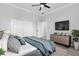 Well-lit primary bedroom with a large window, ceiling fan, walk in closet and a view into the Primary bath at 11884 Se 179Th St, Summerfield, FL 34491
