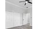 Spacious bedroom showcasing light laminate flooring, a large closet and entry into an ensuite bathroom at 11884 Se 179Th St, Summerfield, FL 34491