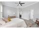 A bedroom with a neutral color scheme, a ceiling fan, and a glimpse into the next room at 11884 Se 179Th St, Summerfield, FL 34491