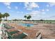 Community swimming pool with palm trees and lounge chairs at 11884 Se 179Th St, Summerfield, FL 34491
