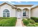 Charming front entrance with arched windows and pillars, plus a cozy seating area at 11884 Se 179Th St, Summerfield, FL 34491