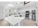 Elegant kitchen features a central island, stainless steel appliances, and white cabinets at 11884 Se 179Th St, Summerfield, FL 34491