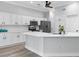 Modern kitchen with white cabinetry, stainless steel appliances, and a spacious island at 11884 Se 179Th St, Summerfield, FL 34491