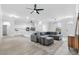 Bright, open-concept living room with a cozy sofa and a view into the kitchen at 11884 Se 179Th St, Summerfield, FL 34491