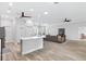 Spacious living room with an island and an open layout leading to the living area at 11884 Se 179Th St, Summerfield, FL 34491