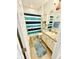 Cozy bathroom featuring nautical themed decor, blue mats and blue striped shower curtain at 1231 Merion Dr, Mount Dora, FL 32757