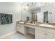 Bright primary bathroom with dual vanities, granite countertops and tiled flooring at 1231 Merion Dr, Mount Dora, FL 32757