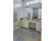 Bathroom featuring double sinks, vanity area, and large mirror with an adjacent walk-in shower at 1231 Merion Dr, Mount Dora, FL 32757