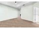 Spacious bedroom with neutral carpet, ceiling fan, and open doorways to other rooms in the home at 1231 Merion Dr, Mount Dora, FL 32757