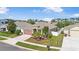Aerial view of a well-maintained home showcasing its lush lawn and neighborhood setting at 1231 Merion Dr, Mount Dora, FL 32757