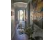 Welcoming home entryway featuring tile floors, a decorative plant, and an artful butterfly painting on the wall at 1231 Merion Dr, Mount Dora, FL 32757
