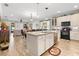 Bright, open kitchen with an island, granite countertops, and white cabinetry at 1231 Merion Dr, Mount Dora, FL 32757