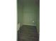 Unfinished laundry room featuring light green walls, hardwood floors, and basic washer/dryer hookups at 1231 Merion Dr, Mount Dora, FL 32757