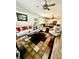 Bright living room featuring a ceiling fan and an open floor plan connected to the dining and kitchen area at 1231 Merion Dr, Mount Dora, FL 32757