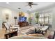 Comfortable living room with tile floors, a ceiling fan, and access to a screened-in porch at 1231 Merion Dr, Mount Dora, FL 32757
