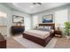 Spacious main bedroom featuring neutral walls, carpet floors, and a cozy king-size bed at 1231 Merion Dr, Mount Dora, FL 32757