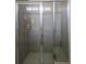 Bathroom tile shower with sliding glass door and built-in shelves at 1231 Merion Dr, Mount Dora, FL 32757