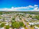 An aerial shot of a quiet residential neighborhood close to a lake, emphasizing its peaceful environment and community layout at 1236 Elkhart Cir, Tavares, FL 32778